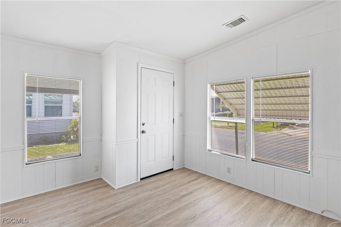 15550 Burnt Store Road, Unit 229 Punta Gorda, FL 33955 - Photo 8 of 41 a view of an empty room with a window and wooden floor