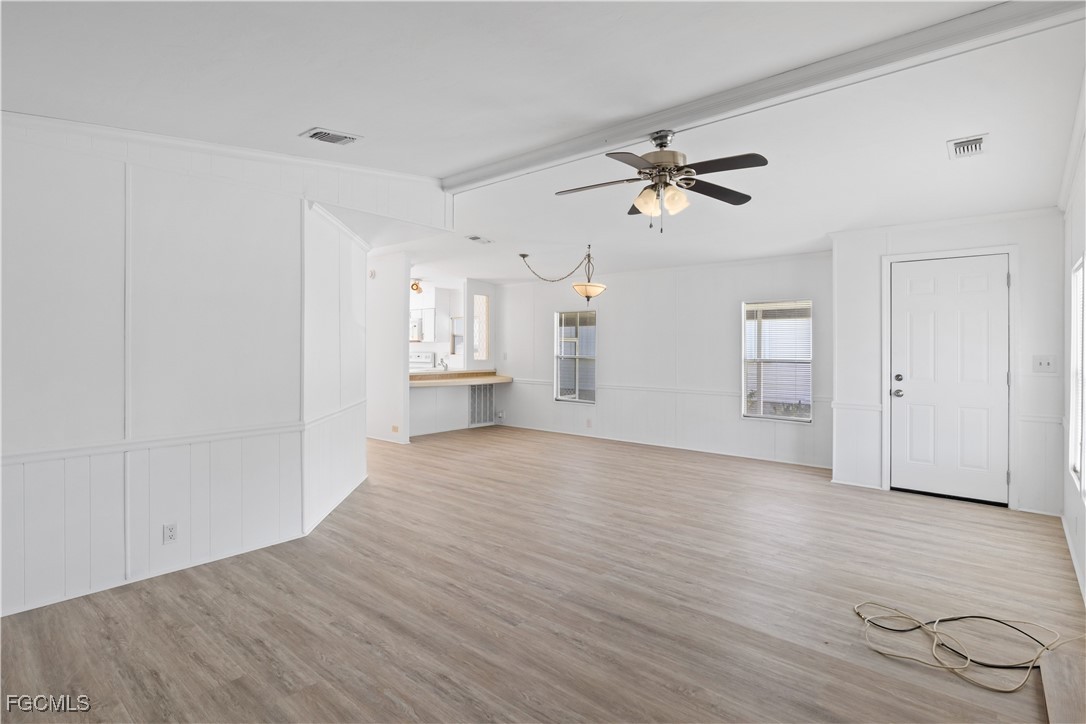 15550 Burnt Store Road, Unit 229 Punta Gorda, FL 33955 - Photo 9 of 41 wooden floor in an empty room with a window