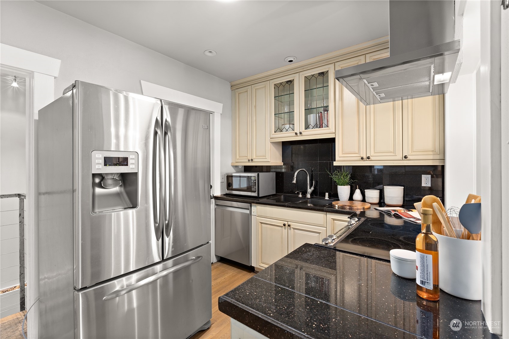 3317 30th Avenue Southwest Seattle, WA 98126 - Photo 11 of 28 a kitchen with stainless steel appliances a refrigerator sink and cabinets