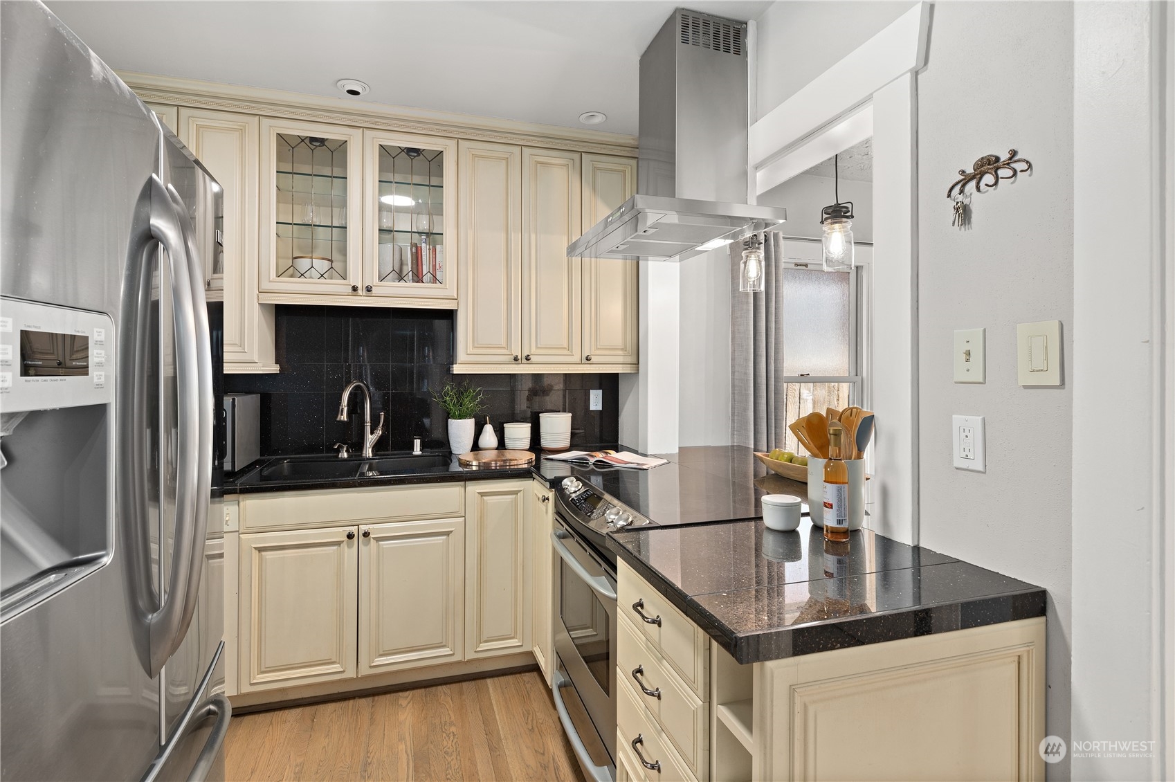 3317 30th Avenue Southwest Seattle, WA 98126 - Photo 12 of 28 a kitchen with stainless steel appliances granite countertop a sink stove and refrigerator