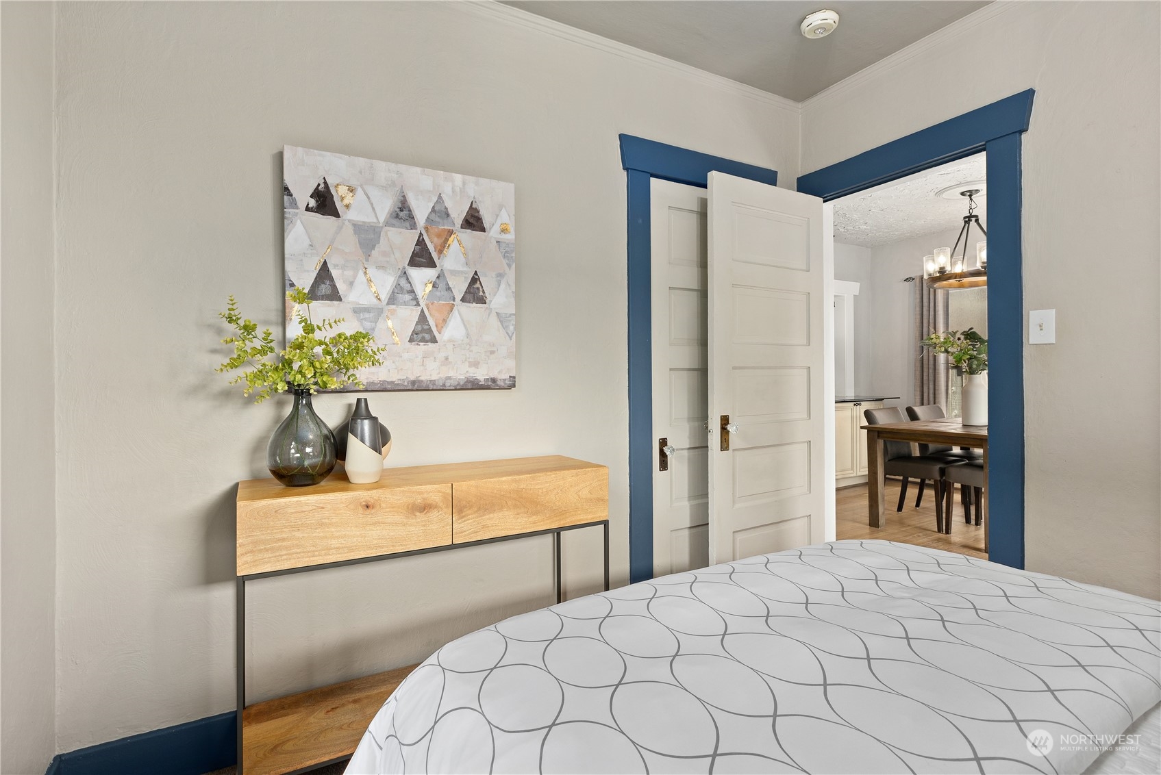 3317 30th Avenue Southwest Seattle, WA 98126 - Photo 15 of 28 a bedroom with a bed and a chandelier