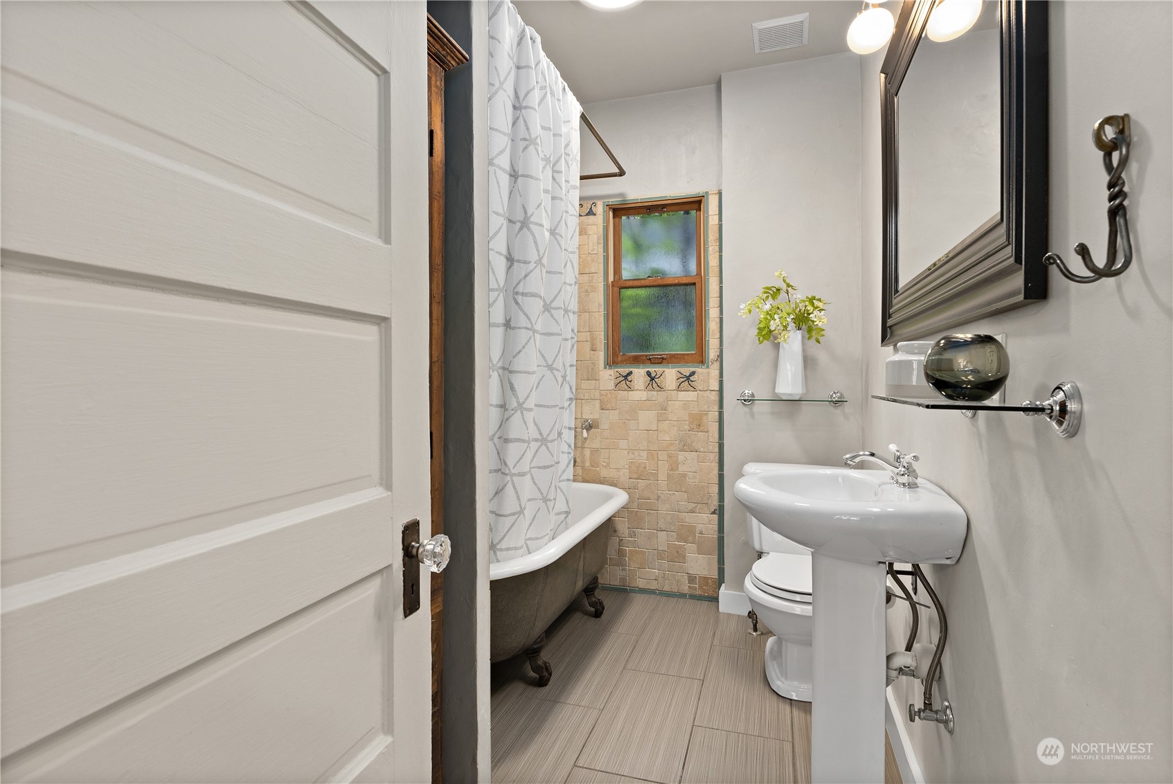 3317 30th Avenue Southwest Seattle, WA 98126 - Photo 16 of 28 a bathroom with a sink a toilet and shower