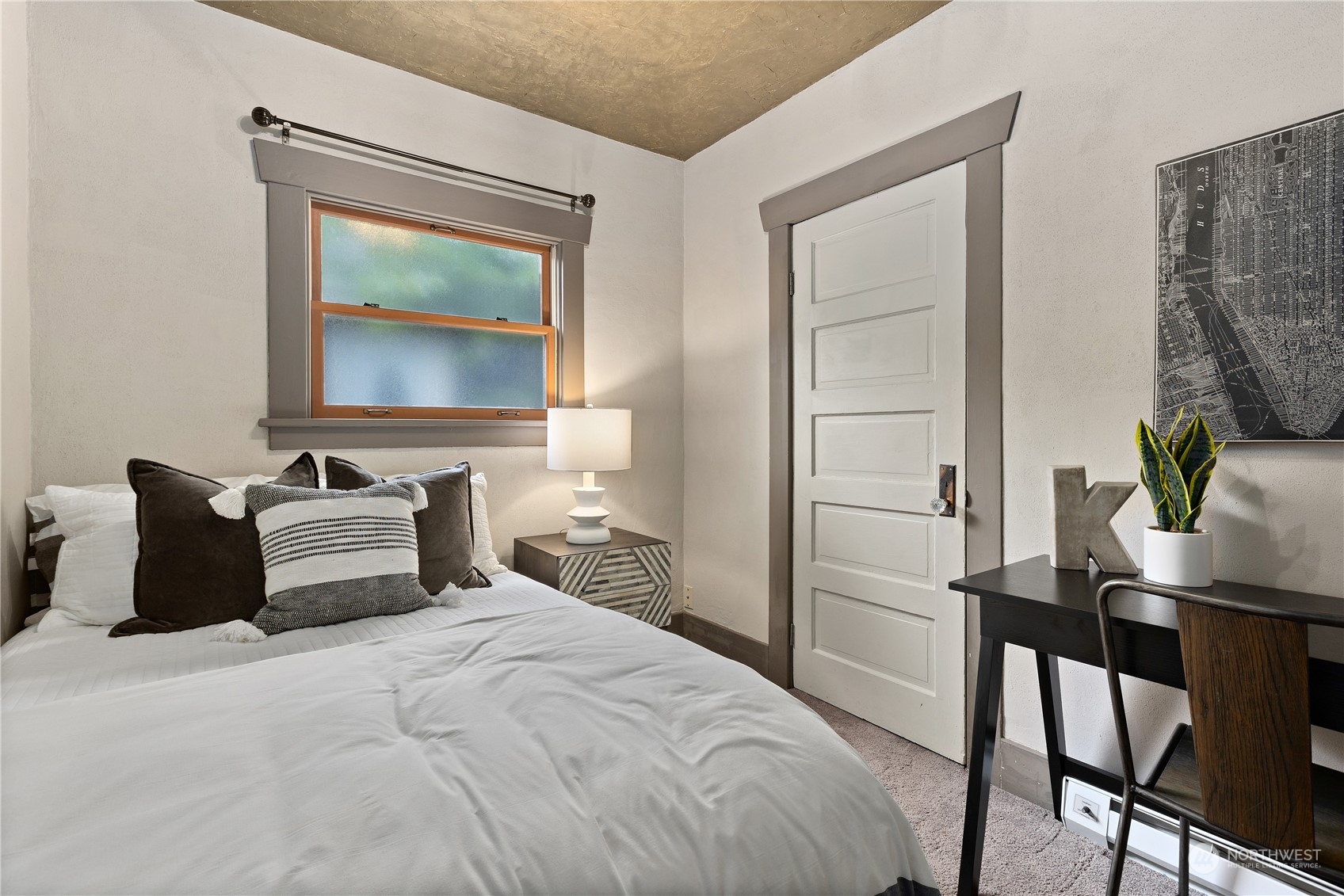 3317 30th Avenue Southwest Seattle, WA 98126 - Photo 17 of 28 a bedroom with a bed and a potted plant