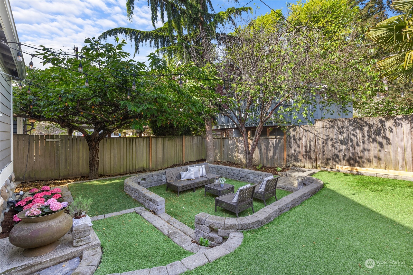 3317 30th Avenue Southwest Seattle, WA 98126 - Photo 26 of 28 a view of a backyard with sitting area and a garden