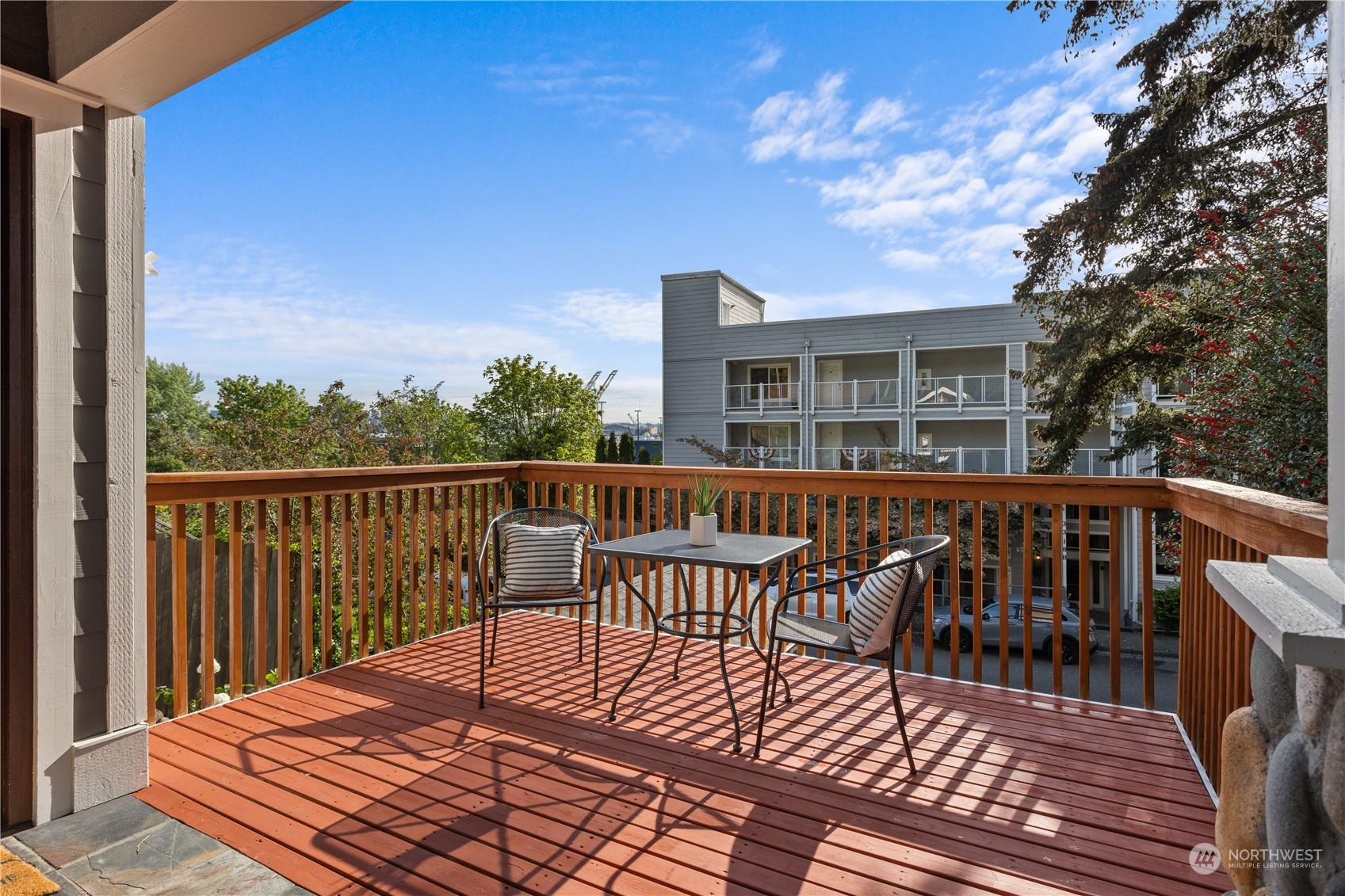3317 30th Avenue Southwest Seattle, WA 98126 - Photo 3 of 28 a view of a roof deck with table and chairs with wooden floor and fence