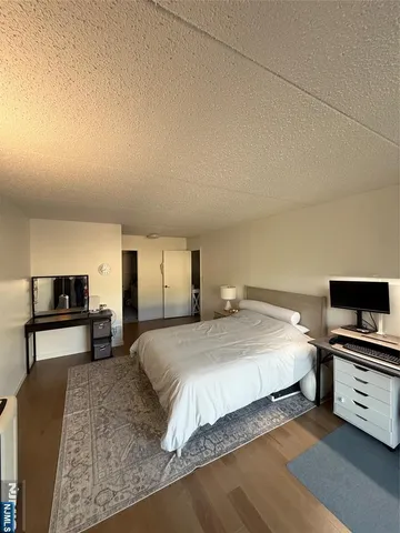 a bedroom with a bed and a tv on table