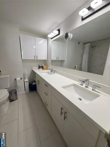a bathroom with a sink double vanity and a mirror