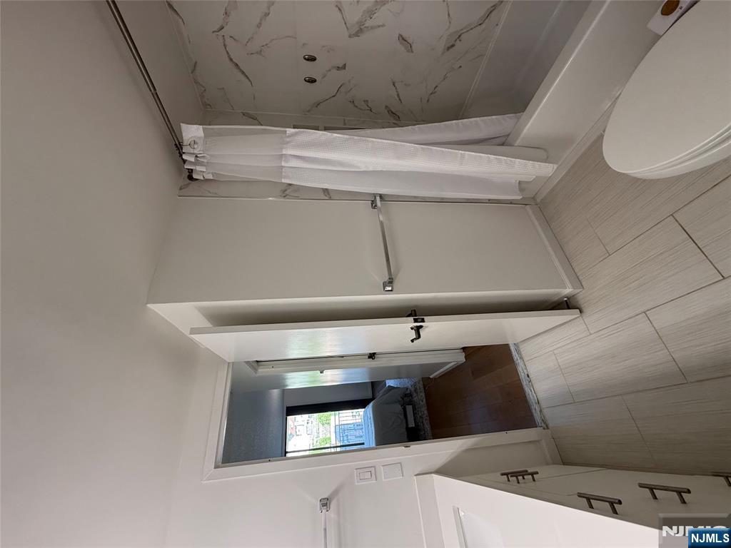 1055 River Road, Unit 504 Edgewater, NJ 07020 - Photo 14 of 17 a bathroom with a sink a toilet and shower