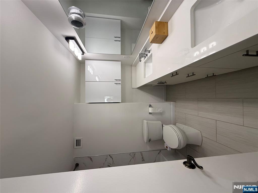 1055 River Road, Unit 504 Edgewater, NJ 07020 - Photo 15 of 17 a spacious bathroom with a sink toilet and shower