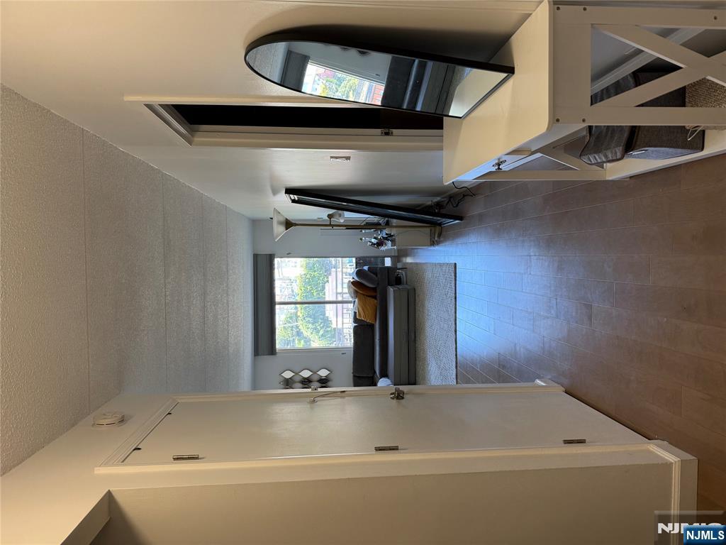 1055 River Road, Unit 504 Edgewater, NJ 07020 - Photo 3 of 17 a view of a livingroom with furniture and a flat screen tv