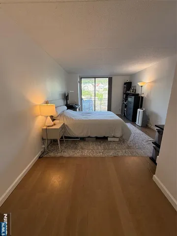 a living room with a bed furniture and a window