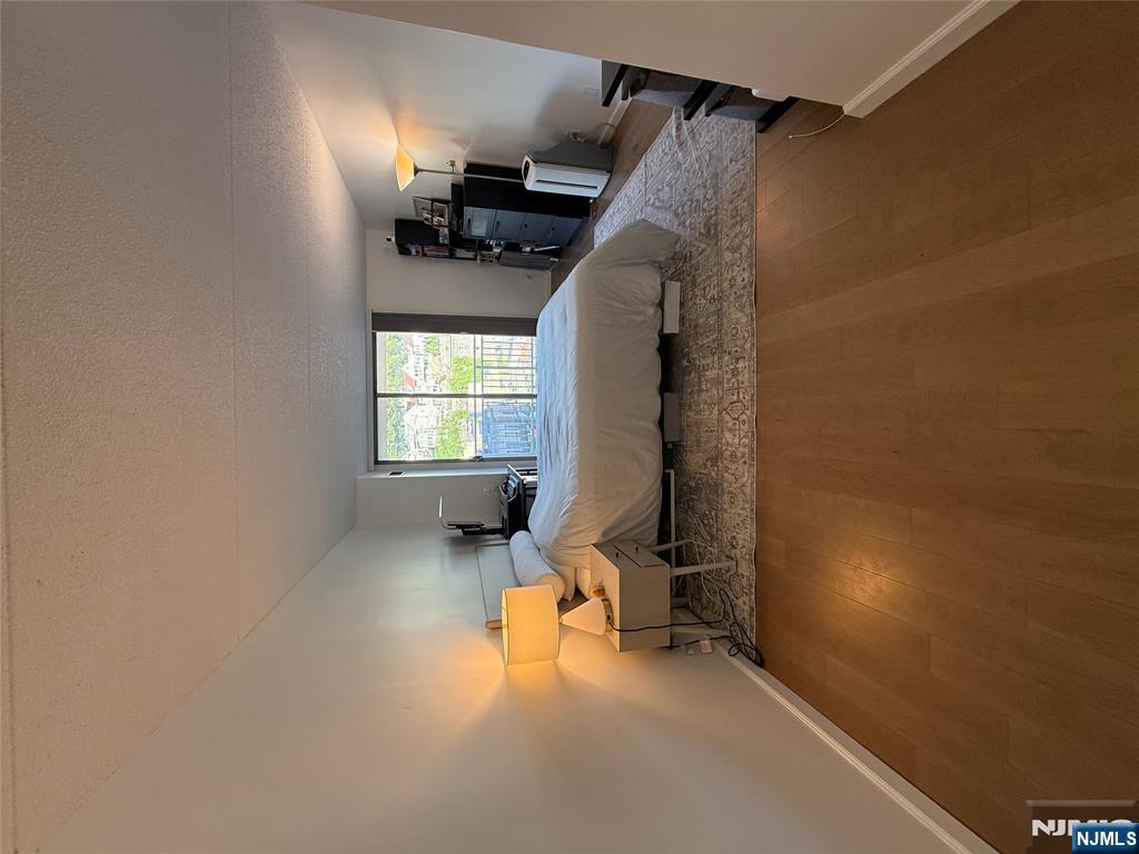 1055 River Road, Unit 504 Edgewater, NJ 07020 - Photo 10 of 17 a living room with a bed furniture and a window