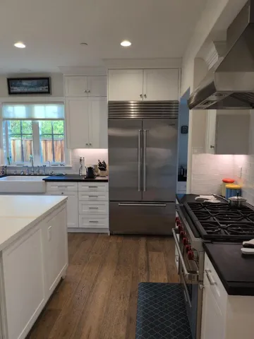 a kitchen with a refrigerator and a sink