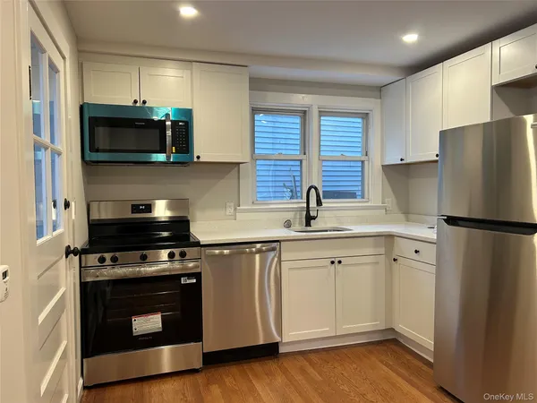 a kitchen with stainless steel appliances a stove a sink and a refrigerator