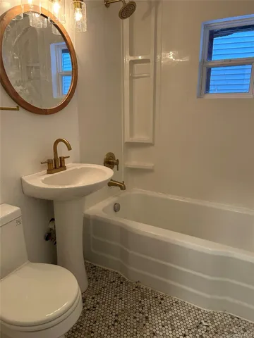 a bathroom with a sink a mirror and a toilet