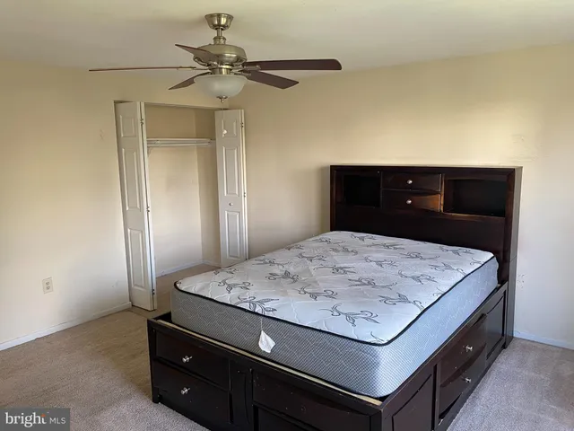 a room with kitchen island a wooden floor and refrigerator a sink dishwasher with wooden floor