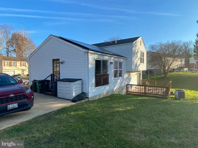 a house view with a sitting space and garden