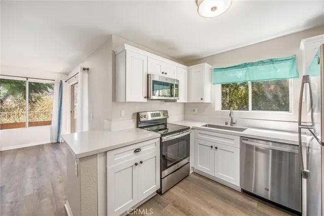 a kitchen with a sink stove and cabinets