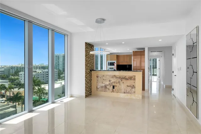 a view of kitchen with stainless steel appliances granite countertop a refrigerator and a sink