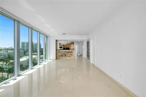 a view of a living room hardwood floor and a kitchen