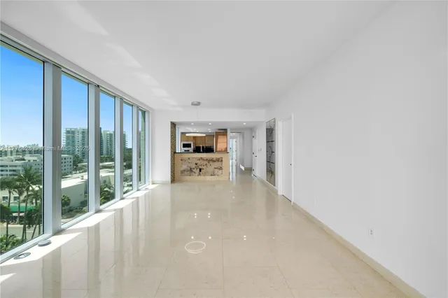 a view of a living room hardwood floor and a kitchen