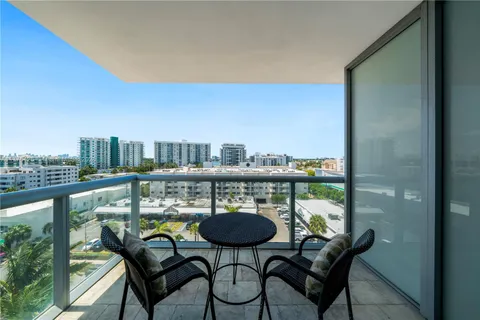 a balcony with table and chairs