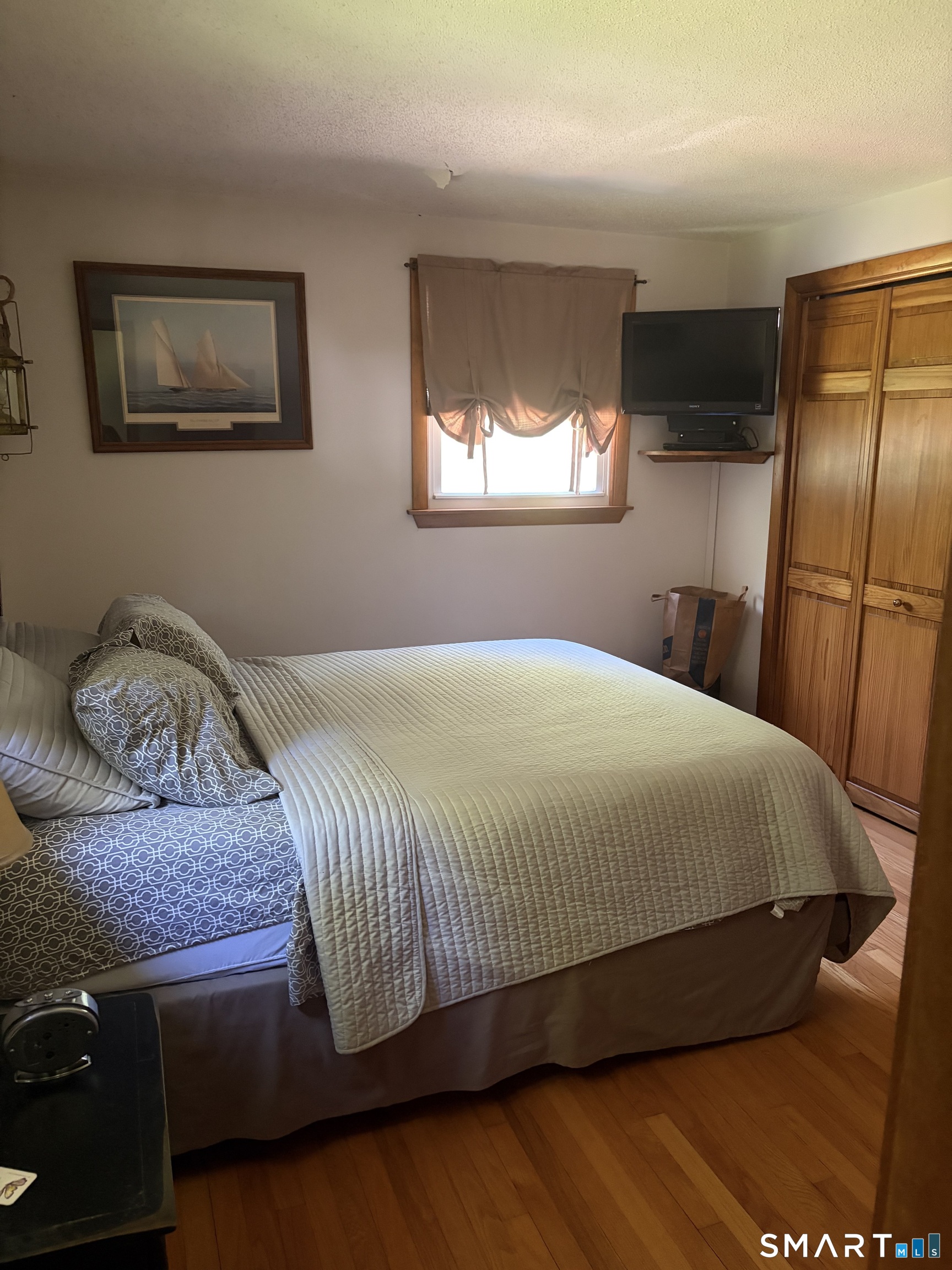 109 Village Hill Road Willington, CT 06279 - Photo 18 of 22 a bedroom with a bed and dresser with mirror