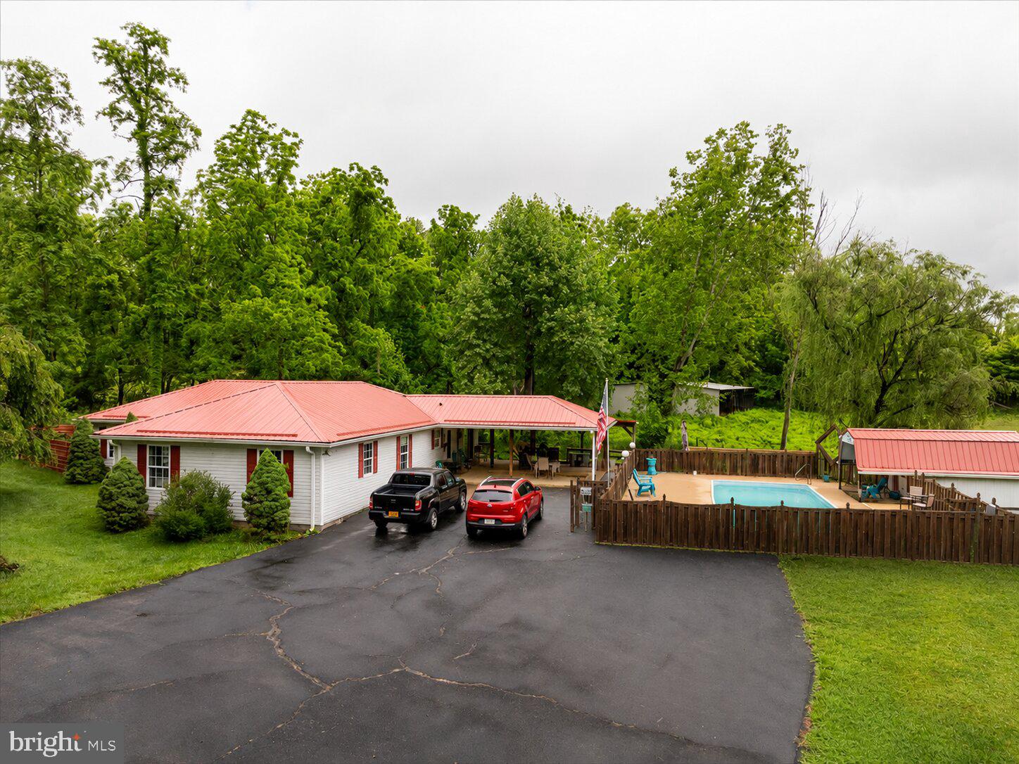 11419 Oak Grove Road Bristol, VA 24202 - Photo 1 of 36 a view of a swimming pool with a table and chairs under an umbrella