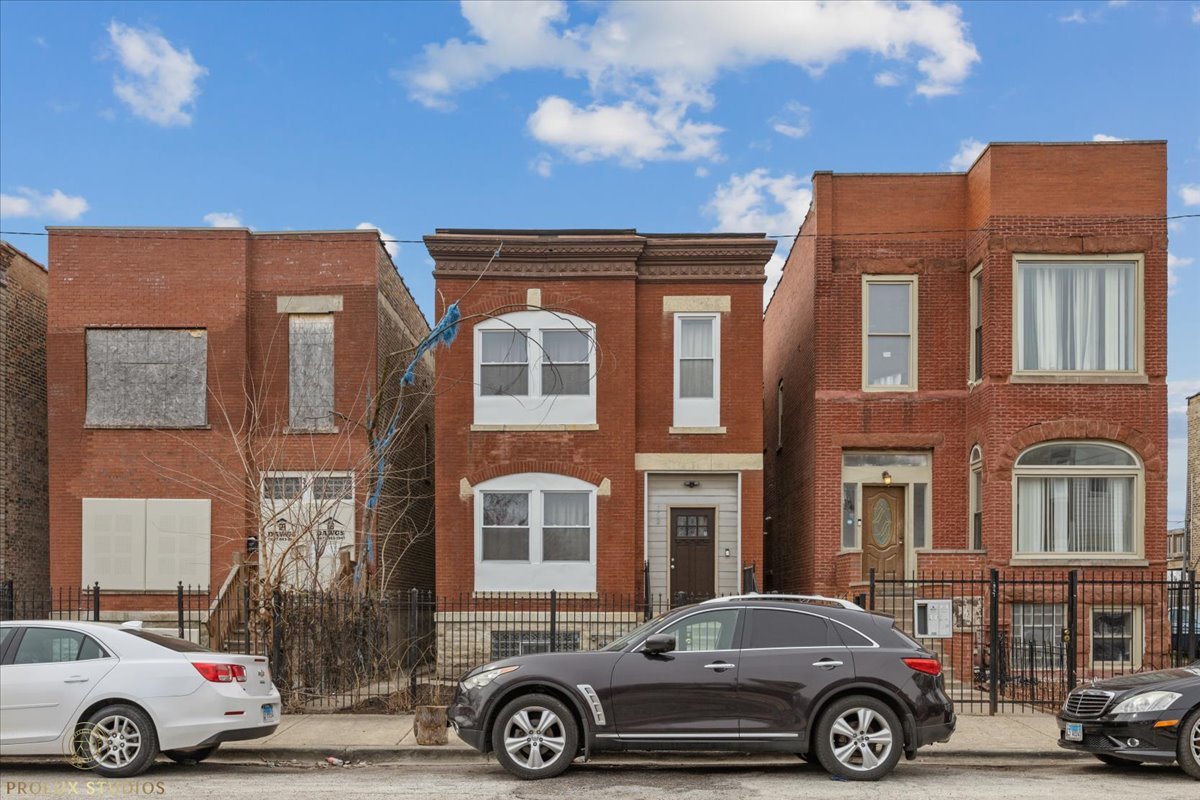 352 North Avers Avenue Chicago, IL 60624 - Photo 1 of 1 a front view of a residential apartment building with a parking space