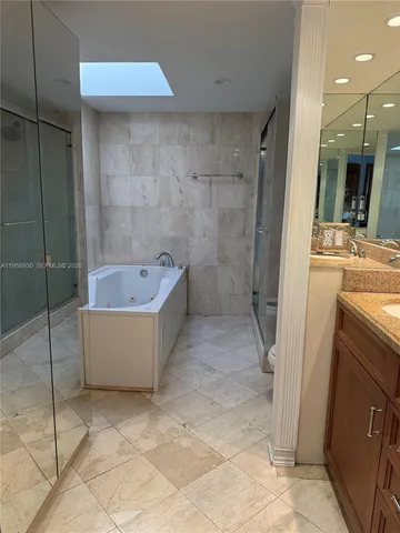 a bathroom with a tub a toilet and a sink