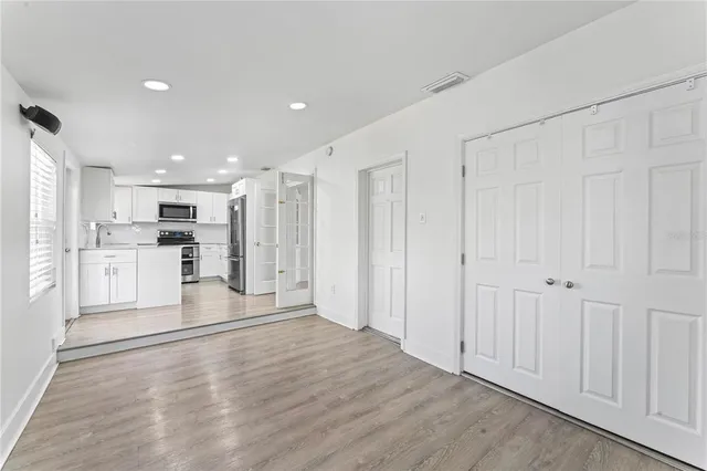 a view of a kitchen with wooden floor