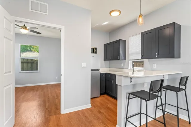 a kitchen with stainless steel appliances granite countertop a sink refrigerator and microwave