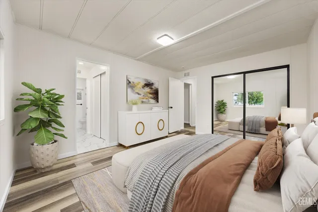 a bedroom with furniture and a potted plant