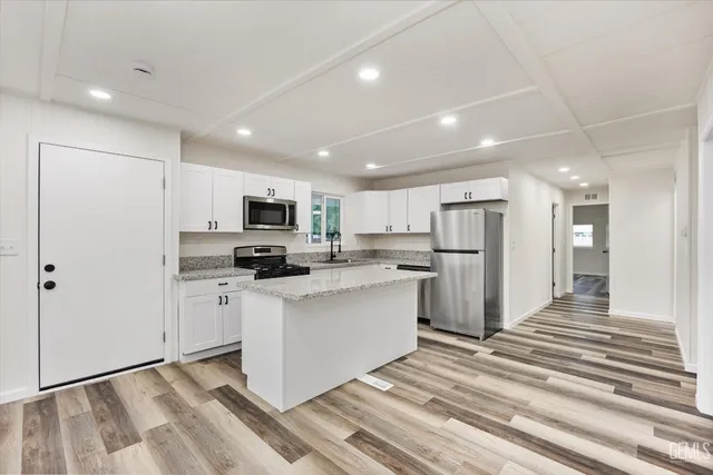 a large kitchen with stainless steel appliances lots of counter top space and cabinets
