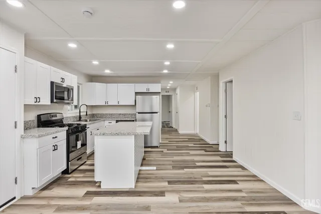 a kitchen with a stove sink and refrigerator