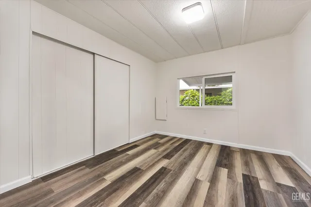 a view of a room with wooden floor