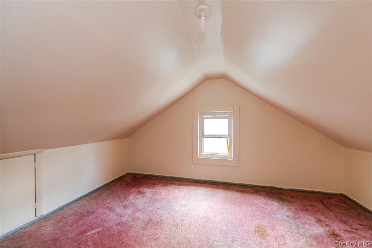 137-27 Thurston Street Queens, NY 11413 - Photo 13 of 19 Additional living space featuring carpet and vaulted ceiling