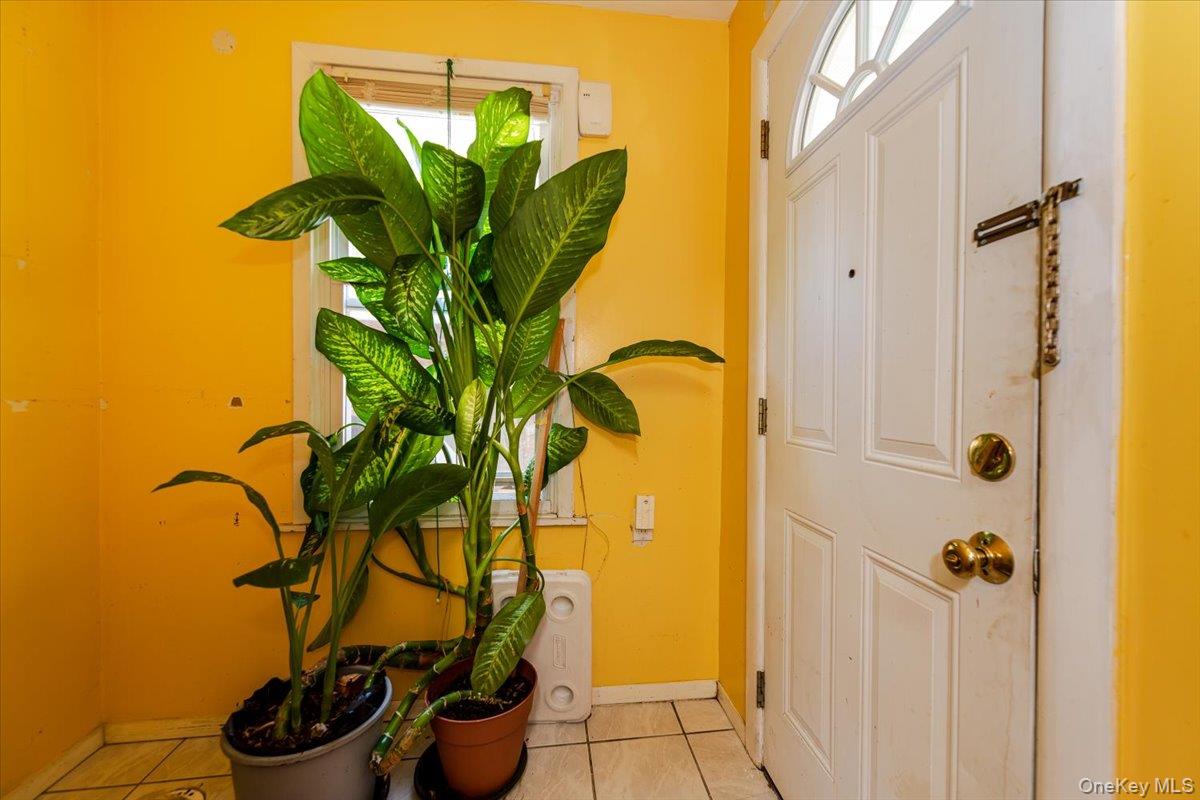 137-27 Thurston Street Queens, NY 11413 - Photo 16 of 19 Tiled foyer entrance featuring baseboards