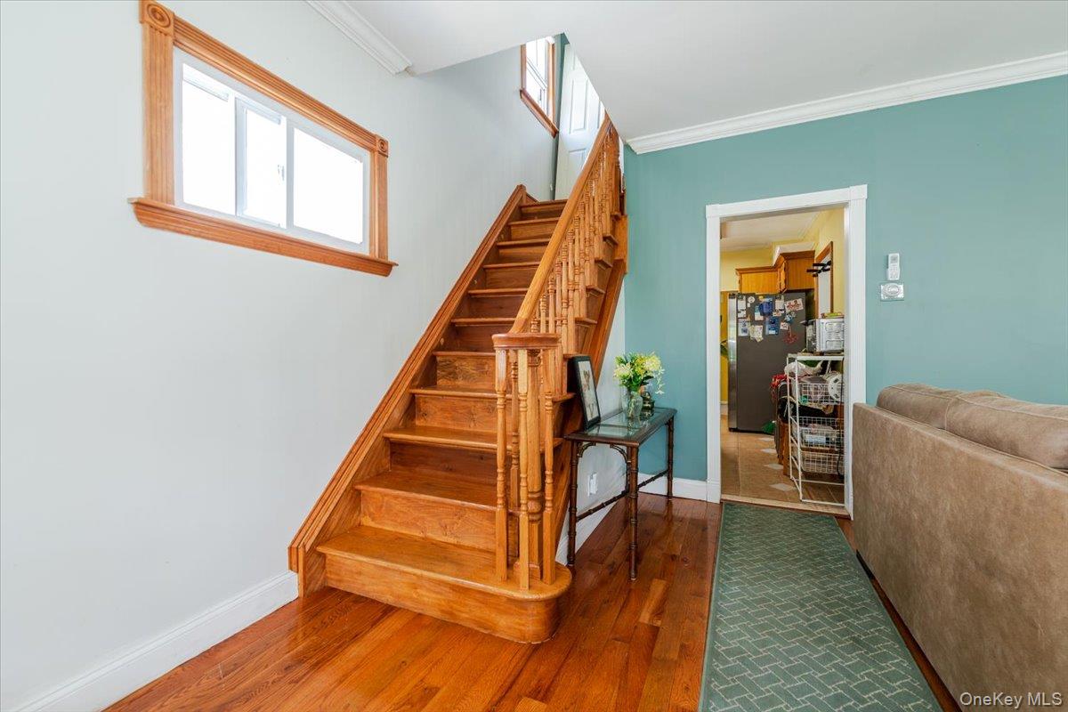 137-27 Thurston Street Queens, NY 11413 - Photo 4 of 19 Stairs with ornamental molding and wood finished floors