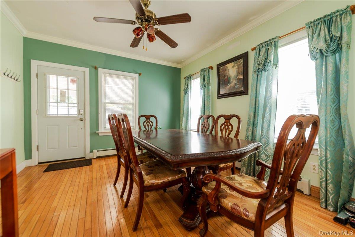 137-27 Thurston Street Queens, NY 11413 - Photo 6 of 19 Dining space with light wood-type flooring, ornamental molding, plenty of natural light, and a ceiling fan
