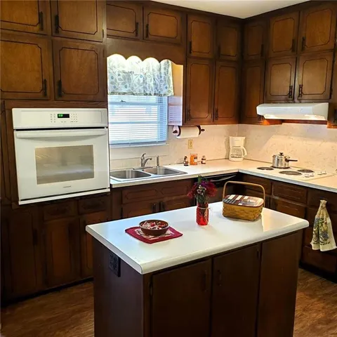 a living room with hard wood flooring and furniture