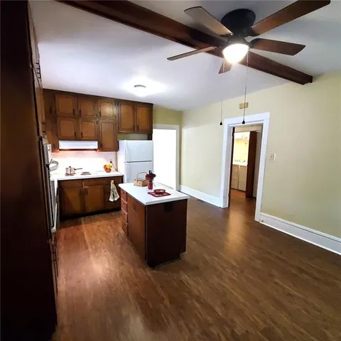 a kitchen with a sink appliances and cabinets