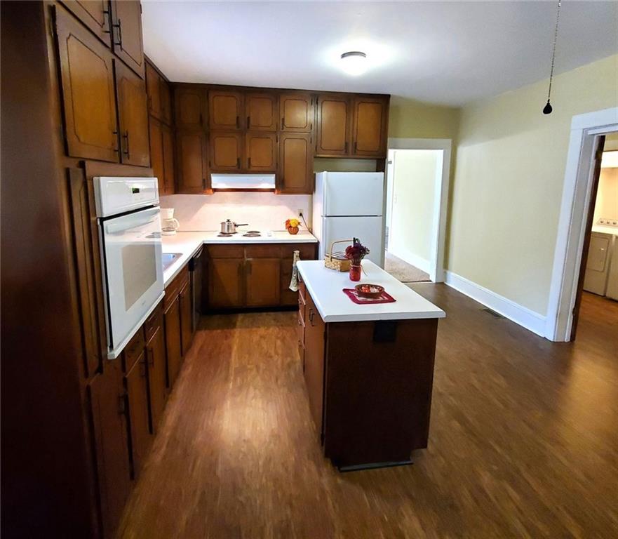7025 Rico Road Chattahoochee Hills, GA 30268 - Photo 19 of 51 a kitchen with a sink appliances and cabinets