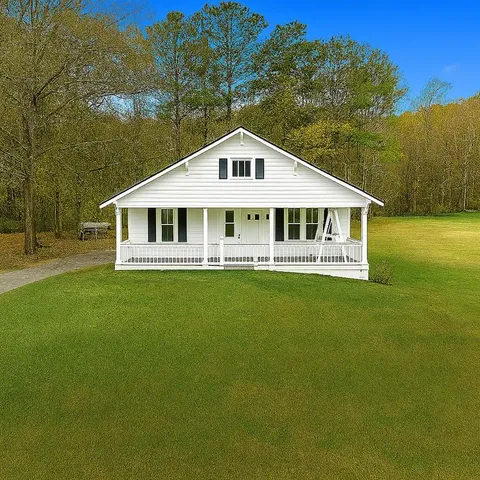 a front view of a house with a yard table and chairs