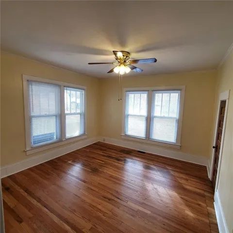 a view of empty room with wooden floor