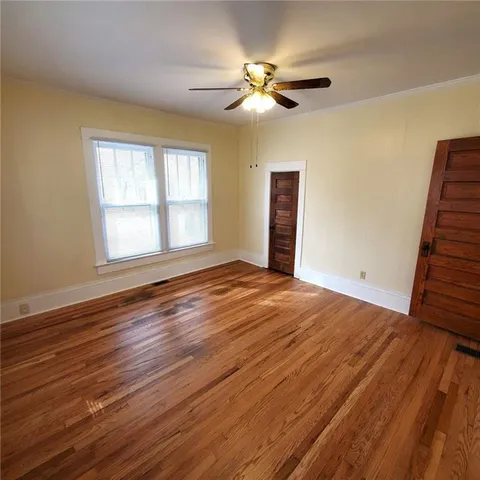 an empty room with wooden floor and closet
