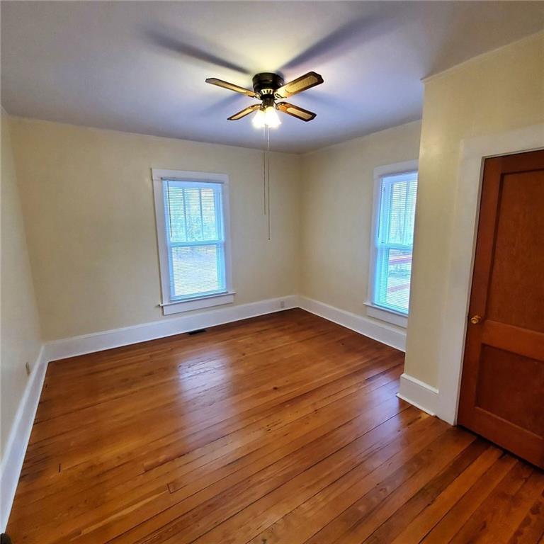 7025 Rico Road Chattahoochee Hills, GA 30268 - Photo 28 of 51 an empty room with wooden floor and window