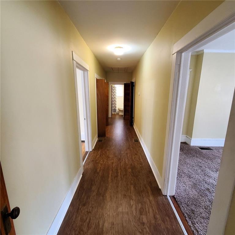 7025 Rico Road Chattahoochee Hills, GA 30268 - Photo 31 of 51 a view of a hallway with wooden floor