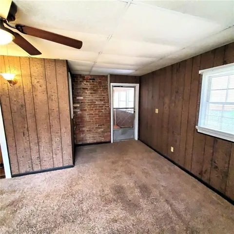 an empty room with windows and closet