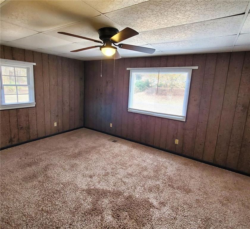 7025 Rico Road Chattahoochee Hills, GA 30268 - Photo 39 of 51 an empty room with windows and fan